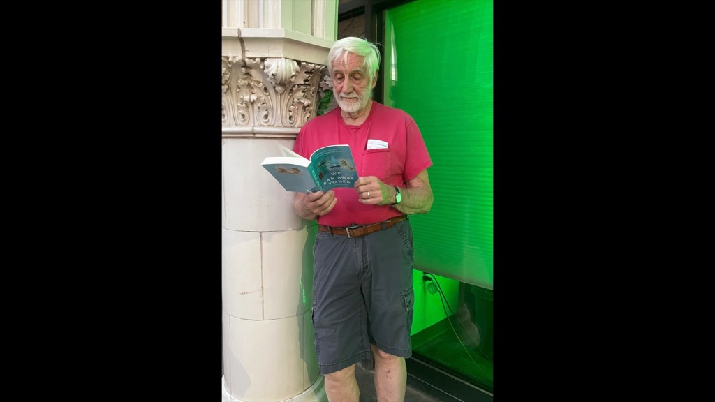 Kent reading We Ran Away to Sea